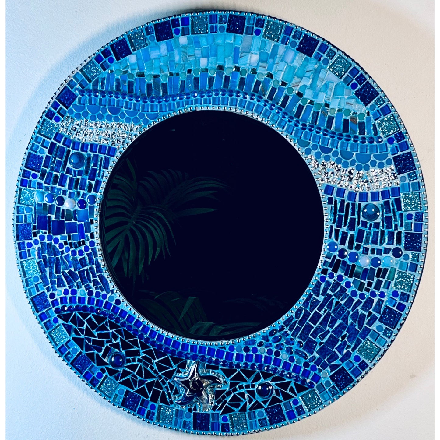 Front View:
18" Mosaic Frame with 10" beveled mirror. In rich ocean hues with glass, ceramic, glass beads and glitter tiles