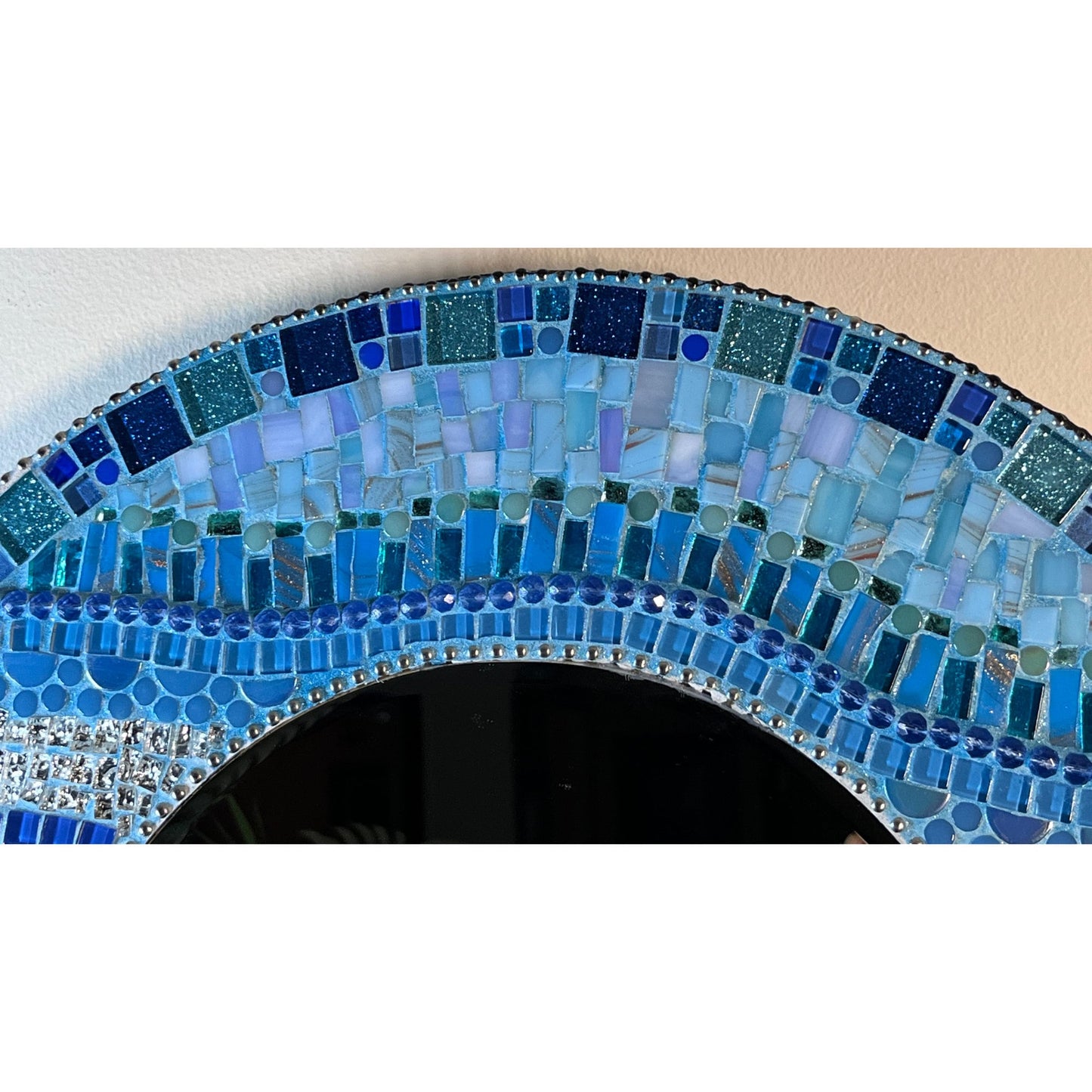 Top View:
18" Mosaic Frame with 10" beveled mirror. In rich ocean hues with glass, ceramic, glass beads and glitter tiles