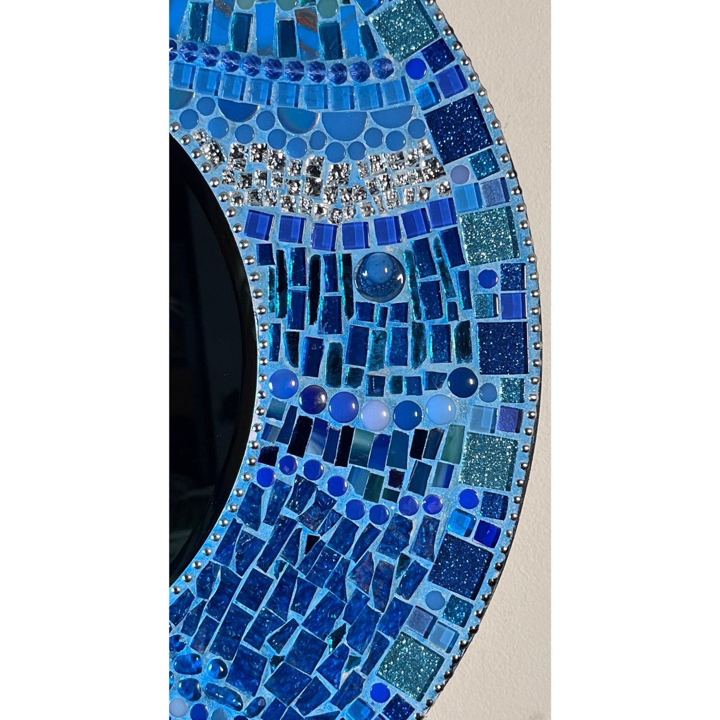 Side View:
18" Mosaic Frame with 10" beveled mirror. In rich ocean hues with glass, ceramic, glass beads and glitter tiles