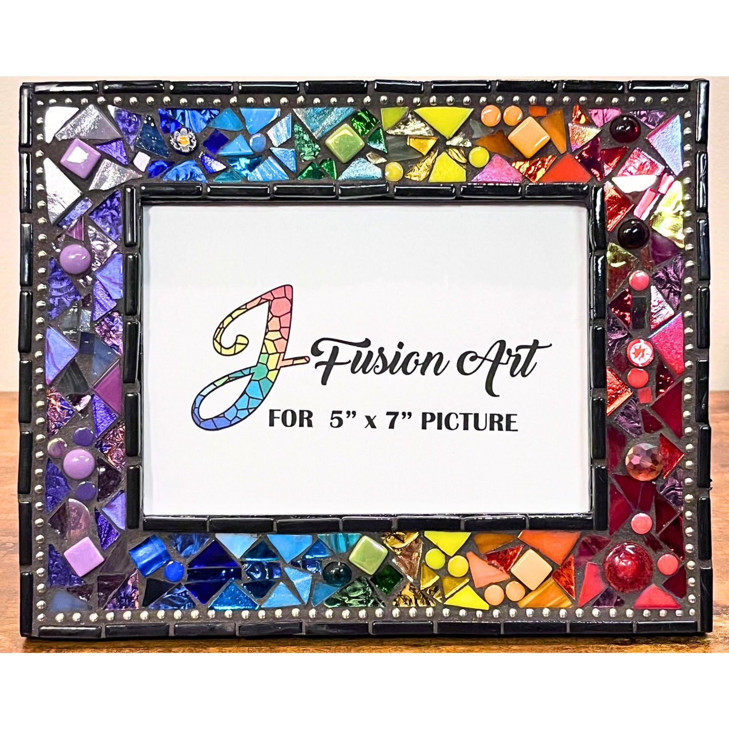 5x7 photo frame in a rainbow of colors. Quite a big of texture with different heights and sizes of files. Glass, stained glass ad ceramic. Black outter border with silver chain inlay