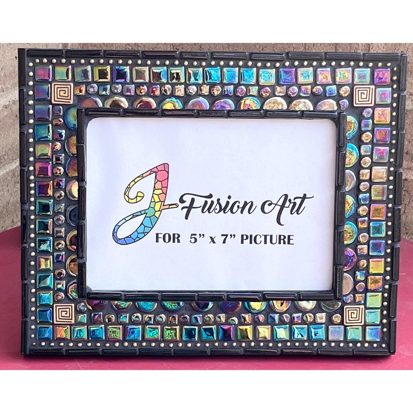 Front View:
5x7 black opal iridescent mosaic tiles with thin black tile outlining the outside as well as the opening for the photo. There are gold square tiles for highlights as well as bronze chain.