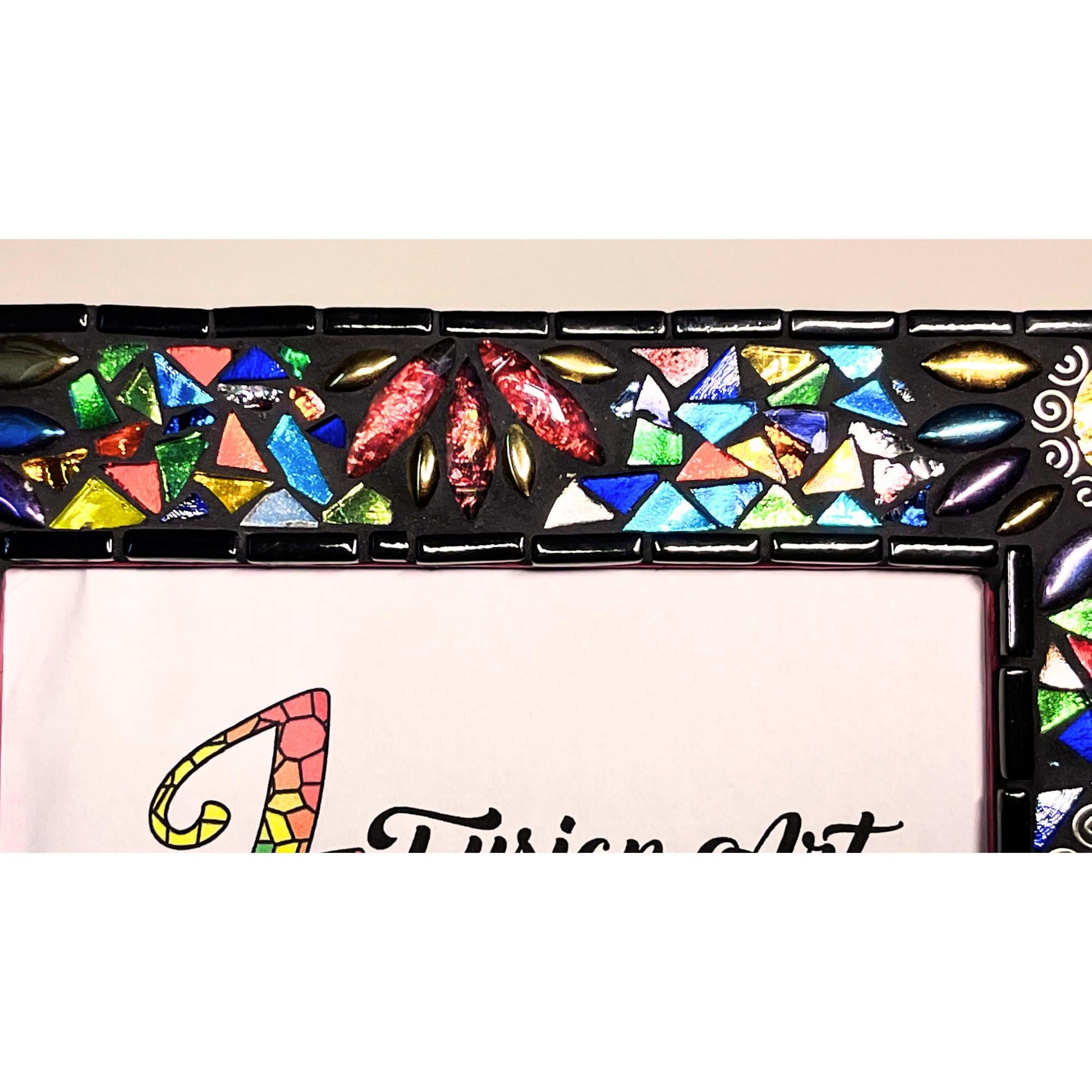 Top Right Side View:
Round Mirrored tiles with tibetan silver bead outlines.  Iridescent Leaves and assorted colored glass tile triangles.  Border of the Mirror is in black as is the grout color.