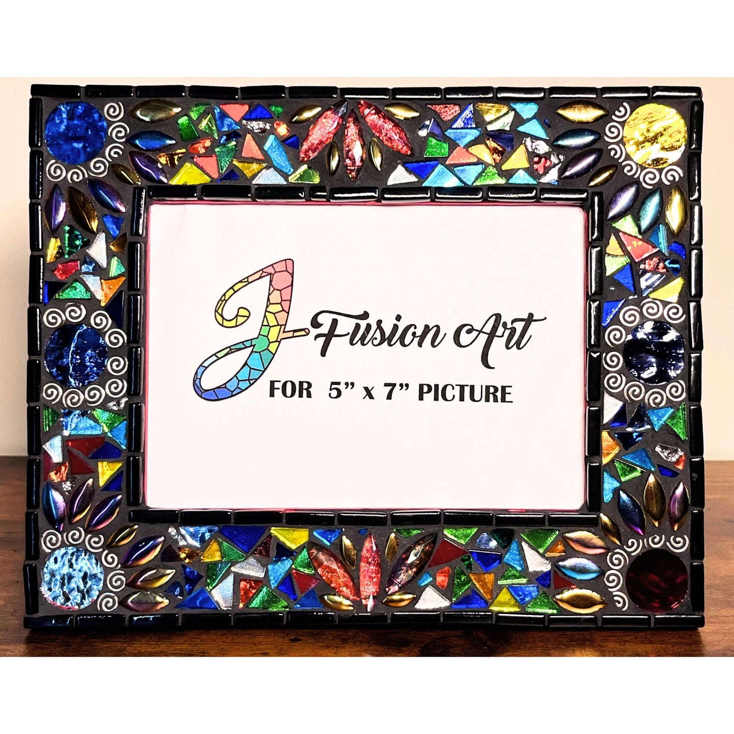 Front View:  
5x7 Photo Frame:Round Mirrored tiles with tibetan silver bead outlines.  Iridescent Leaves and assorted colored glass tile triangles.  Border of the Mirror is in black as is the grout color.