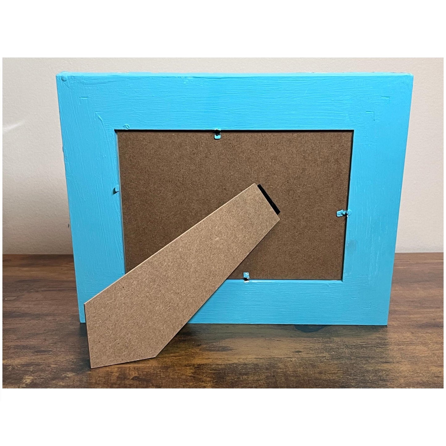 back showing blue painted frame with easel back. Horizontal