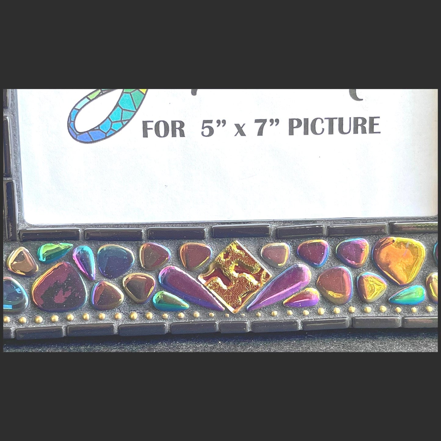 bottom middle close up:
5x7 Photo Frame:  Various sized Pebble Shaped Iridescent tiles.  Also Iridescent mosaic leaves and gold textured tiles.  Border of frame in black tiles with a silver ball chain inside of the border for contrast.  Grouted in black mosaic grout.