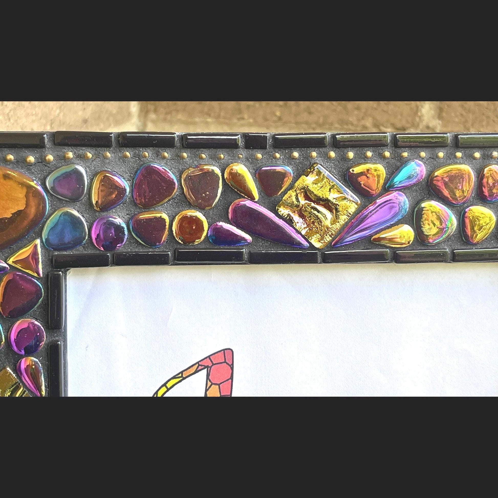 Top middle and left side close up:
5x7 Photo Frame:  Various sized Pebble Shaped Iridescent tiles.  Also Iridescent mosaic leaves and gold textured tiles.  Border of frame in black tiles with a silver ball chain inside of the border for contrast.  Grouted in black mosaic grout.