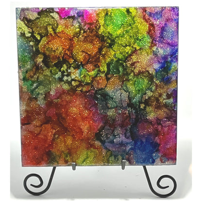 10 inch wood panel covered in silver glitter and resin, topped with alcohol inks and layers of resin