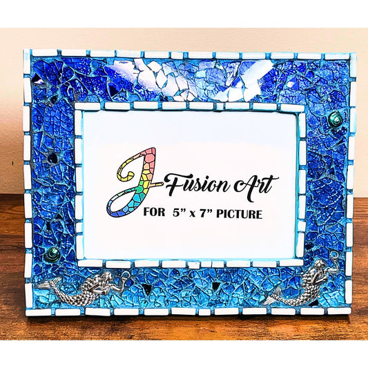 Front view:
5 x 7 tempered glass and mosaic photo frame in shades of blue with silver mermaid charms on the bottom