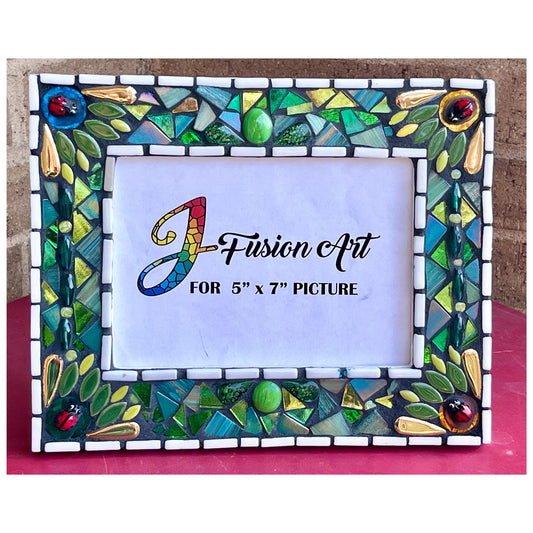 Front View:
5 x 7 Photo frame is shades of green with ceramic leaves, glass beads and tiles.  Gold Accents and ladybug fused glass in the four corners.