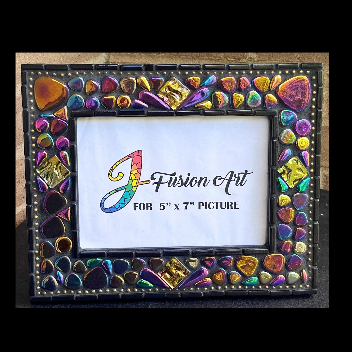 Front View:  
5x7 Photo Frame:  Various sized Pebble Shaped Iridescent tiles.  Also Iridescent mosaic leaves and gold textured tiles.  Border of frame in black tiles with a silver ball chain inside of the border for contrast.  Grouted in black mosaic grout.